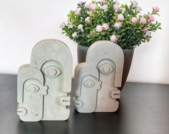 Concrete sculpture depicting 2 lovely faces to decorate a modern home