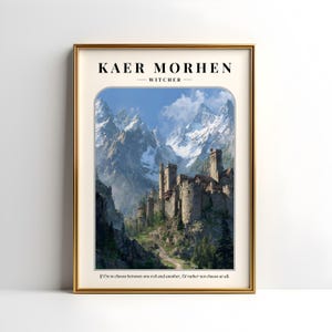 May include: A framed print featuring a scenic landscape of a castle nestled in a mountain range. The text "KAER MORHEN - WITCHER" is at the top, with a quote at the bottom. The frame is gold.