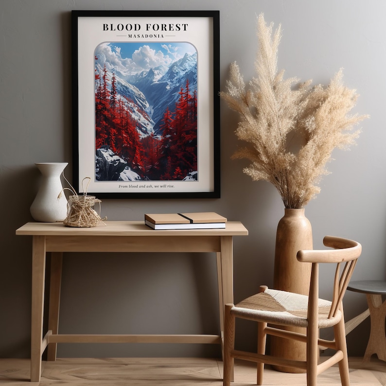 May include: A framed poster with a mountain landscape and red trees. The poster has the text "BLOOD FOREST - MASADONIA" and the quote "From blood and ash, we will rise."