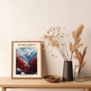 May include: A framed print of a mountain landscape with a red forest in the foreground. The print has the text "BLOOD FOREST - MACEDONIA - From blood and ash, we will rise."