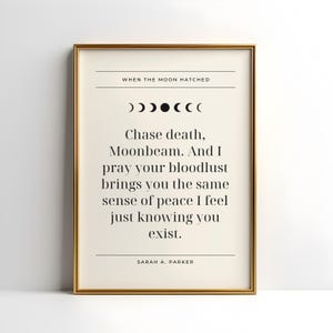 May include: A framed print with a gold-colored frame. The print features the text "WHEN THE MOON HATCHED" above a series of moon phase symbols. Below, the text reads "Chase death, Moonbeam..." and is signed "SARAH A. PARKER."