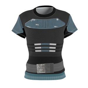 May include: A short-sleeved black t-shirt featuring a printed design that mimics armor. The chest displays a weathered blue plate, while the midsection includes horizontal gray and blue stripes. A gray belt graphic sits at the waistline.