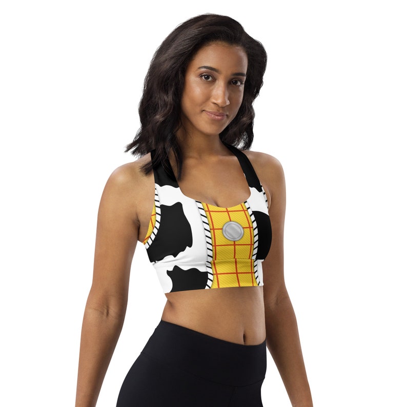 May include: A black and white sports bra with a yellow and red pattern. The pattern is reminiscent of a popular cartoon character's outfit.
