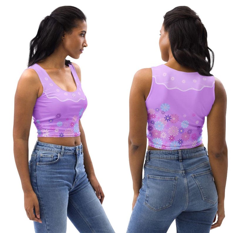 May include: A sleeveless lavender crop top featuring a white scalloped neckline detail and a vibrant floral pattern in shades of blue, purple, and pink across the bottom hem, paired with blue denim jeans shown from side and back views.