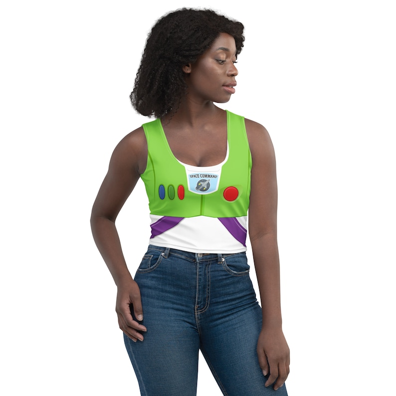 May include: A green and white crop top with a design inspired by the character Buzz Lightyear. The top features a green bodice with red and purple accents, and the words "SPACE COMMAND" are printed on the chest.