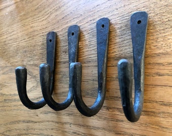 Four lovely hand made wrought iron blacksmiths hooks