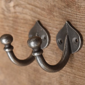 A lovely Pair of cast iron round top single coathook wall hook hanger with screws