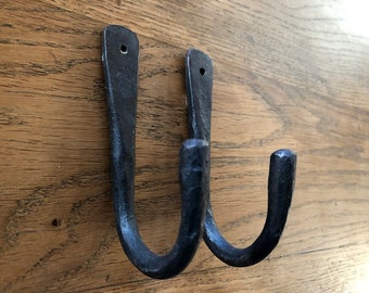 A pair of lovely hand made wrought iron blacksmiths hooks