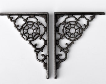 A pair of lovely decorative antique style iron shelving brackets