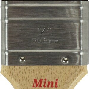 May include: A 2-inch, wooden-handled paint brush with a silver ferrule. The brush is labeled "Mini" and "Dixie Belle" and says "Made in USA".