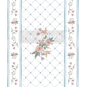 May include: A white background with a blue and white diamond pattern. The center of the image features a cluster of pink and white flowers with green leaves. The sides of the image feature a blue stripe with a repeating pattern of pink flowers.