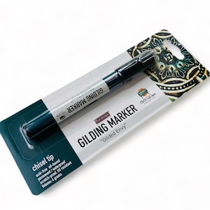 May include: A black and green gilding marker with a chisel tip. The marker is labeled "re-design GILDING MARKER "Gilded Envy"  Volume: 4 grams".