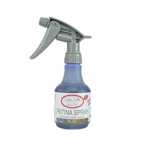 May include: A blue bottle of Dixie Belle Fast Company Patina Spray for bronze, copper, and iron. The bottle has a gray spray nozzle and the label says "Patina Spray" and "Blue".
