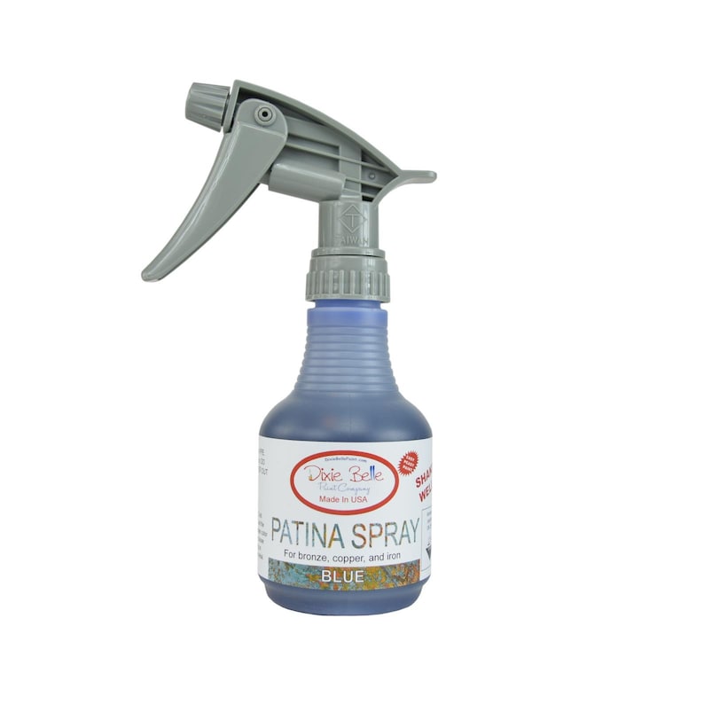 May include: A blue bottle of Dixie Belle Fast Company Patina Spray for bronze, copper, and iron. The bottle has a gray spray nozzle and the label says "Patina Spray" and "Blue".