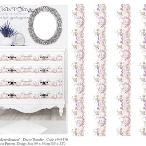 May include: A white dresser with five drawers decorated with a floral pattern transfer. The pattern features pink, purple, and white roses with green leaves. The transfer is 35 inches by 22 inches.
