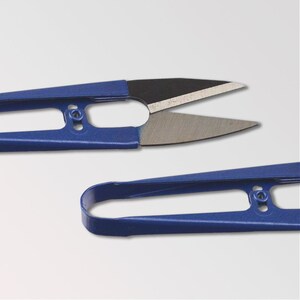May include: Blue metal sewing scissors with a pointed tip and a small hole in the handle. The scissors are open and the blades are visible.