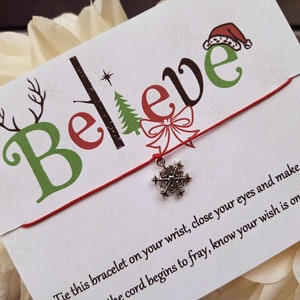 May include: Red string bracelet with a silver snowflake charm and a card that says "Believe" with a Christmas tree and reindeer design. The card also includes instructions to tie the bracelet on your wrist, close your eyes, and make a wish. The card says when the cord begins to fray, your wish is on its way.
