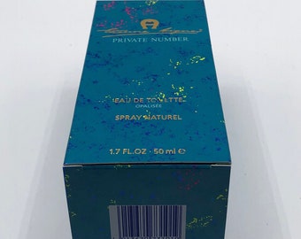 May include: A teal blue box with a colorful design and a barcode. The box contains a bottle of Private Number Eau de Toilette Opalisée Spray Naturel, 1.7 fl oz / 50 ml.
