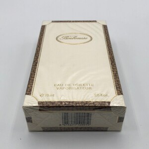 May include: A white box with gold trim and the text "Bourbonnese Eau de Toilette Vaporisateur" on the front. The box has a barcode on the bottom and the text "75 ml" and "2.5 fl.oz."
