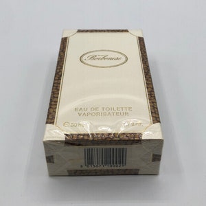 May include: A rectangular perfume box with the brand name "Borbonese" in gold lettering. The box is cream-colored with a brown, textured border. The text "EAU DE TOILETTE VAPORISATEUR" is printed on the front. The box contains 1.7 fl oz.