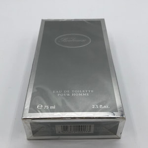 May include: A silver box with a silver label that reads "Eau de Toilette Pour Homme" and "e 75 ml 2.5 fl.oz.". The box has a barcode that reads "8 015671 100173".