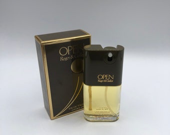 May include: A brown box with gold lettering that reads "OPEN Roger & Gallet" and a brown and gold bottle of perfume with the same text. The bottle is labeled "Eau de Toilette Natural Spray" and "Vaporisateur Eau de Toilette".