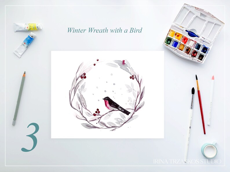 May include: Watercolor painting of a winter wreath with a bird. The wreath is gray with red berries and a black bird with a red breast. The text "Winter Wreath with a Bird" is above the painting. Paint tubes, pencils, and brushes are also visible.