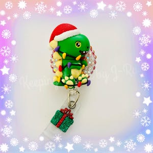 Adorable Christmas dinosaur badge reel