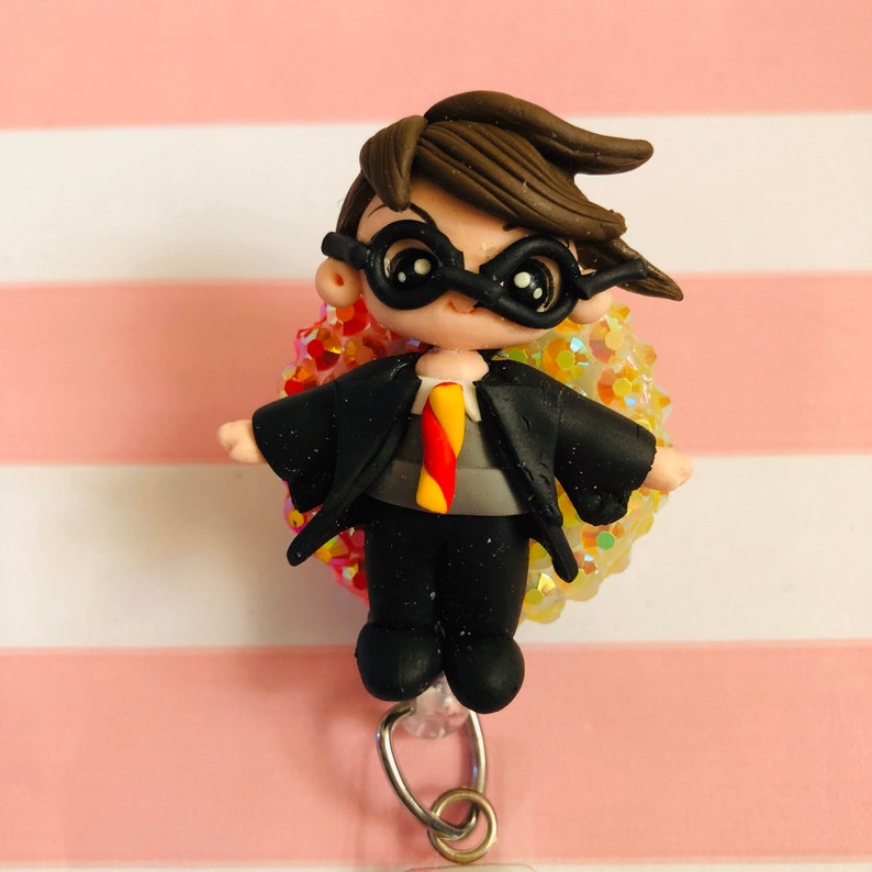 Red and gold Wizard boy clay doll badge reel