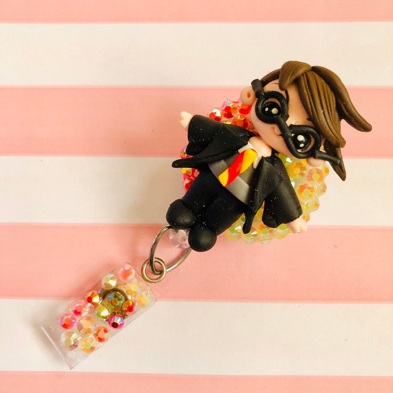 Red and gold Wizard boy clay doll badge reel