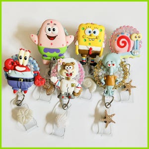 Cartoon sponge, crab, squirrel, squid, starfish and friends badge reel