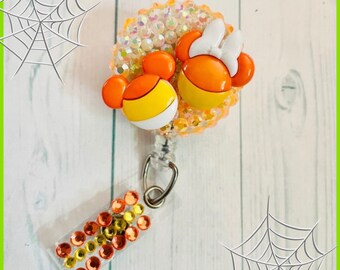 Mickey and Minnie themed candy corn badge reel