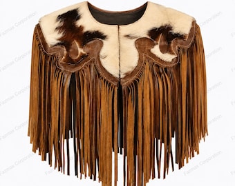 May include: A brown suede capelet featuring long fringe detailing along the bottom edge. The upper section is accented with a white and dark brown cowhide pattern, featuring a scalloped leather trim that separates the hide from the fringe.