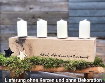 May include: Wooden Advent candle holder with four candle slots. The holder is decorated with moss and stars. The text "Advent, Advent ein Lichtlein brennt" is engraved on the front.