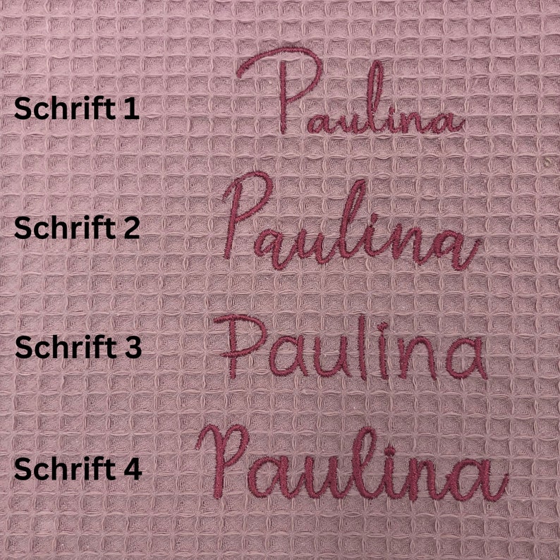 May include: Four different font styles of the name "Paulina" embroidered on a pink waffle weave fabric. The text "Schrift 1", "Schrift 2", "Schrift 3", and "Schrift 4" are written in black to the left of each name.