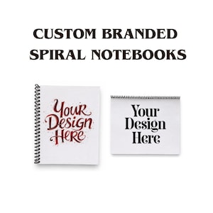 May include: Two white spiral notebooks with black wire binding. The left notebook features red cursive text reading 'Your Design Here'. The right notebook features black serif text reading 'Your Design Here'. Above the notebooks, the text reads 'CUSTOM BRANDED SPIRAL NOTEBOOKS'.