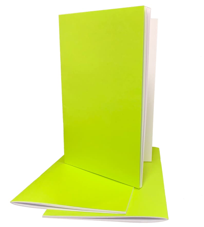 May include: Three lime green notebooks with white spines stacked on top of each other.