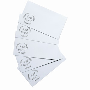 May include: Five white envelopes with a black and white floral wreath design and the text "A gift for you!" printed on each.
