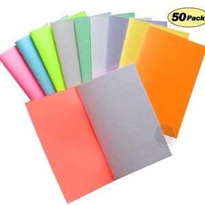 May include: A pack of 50 brightly colored paper notebooks. The notebooks are arranged in a fan shape, with the covers facing outward. The colors include pink, light blue, neon green, light gray, light green, lavender, yellow, and orange.