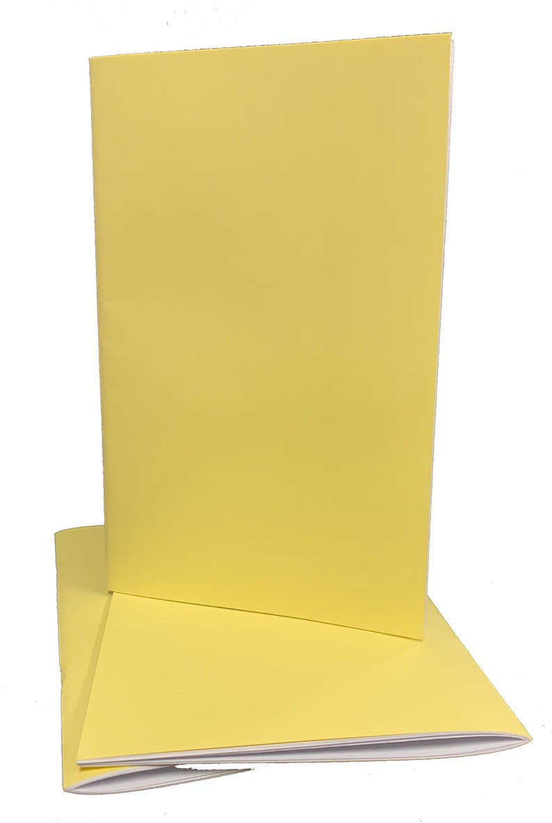 May include: Two yellow notebooks stacked on top of each other. The notebooks are closed and have a white edge.
