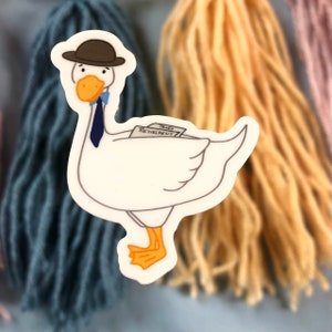 May include: A white goose wearing a brown hat and a blue tie. The goose is holding a stack of papers that say "Taxes Retirement".