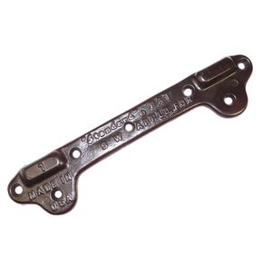 May include: A dark brown metal bracket with multiple holes and a curved end. The text "Standard Pat. Applied For" and "Made in USA" are visible. The number "1" is also stamped on the bracket.