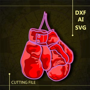 Op de afbeelding: Een paar rode bokshandschoenen met een roze omtrek, hangend aan een touwtje. De handschoenen hebben een getextureerd oppervlak en zijn aan de polsen aan elkaar gebonden. De afbeelding bevat de tekst "DXF AI SVG CUTTING FILE".