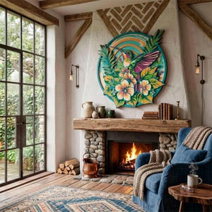 May include: A circular wooden wall art piece featuring a colorful hummingbird surrounded by tropical flowers and leaves in shades of teal, orange, purple, and green, mounted above a stone fireplace with a wooden mantel and a burning fire.