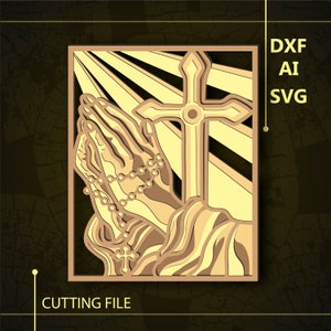 May include: A laser cut design of praying hands with a rosary and a cross, with a sunburst effect in the background.  The design is in shades of gold.