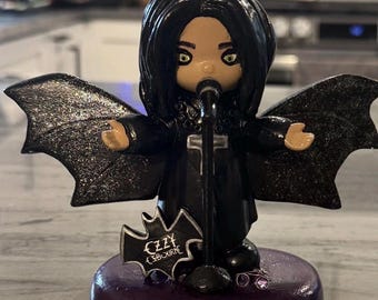 Ozzy Osbourne with bat wings altered from a precious moment figurine