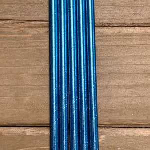 K&ouml;nnte beinhalten: Ein Set mit sechs blauen, metallischen Papierstrohhalmen. Die Strohhalme sind gestreift und haben eine gl&auml;nzende Oberfl&auml;che.
