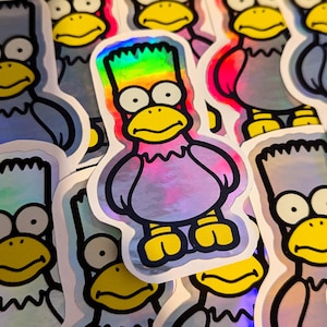 May include: A collection of iridescent stickers featuring a cartoon character with a yellow beak and blue hair. The stickers are on a white background.