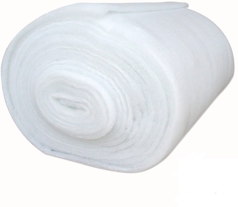 May include: A white, rolled up piece of batting, a type of fiberfill used for quilting and crafts.