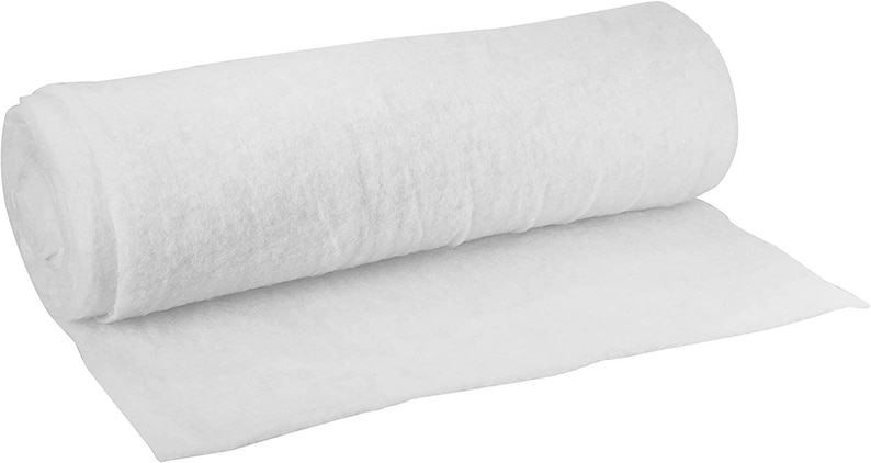 May include: A white, rolled up piece of landscape fabric. This fabric is used to prevent weeds from growing in gardens.